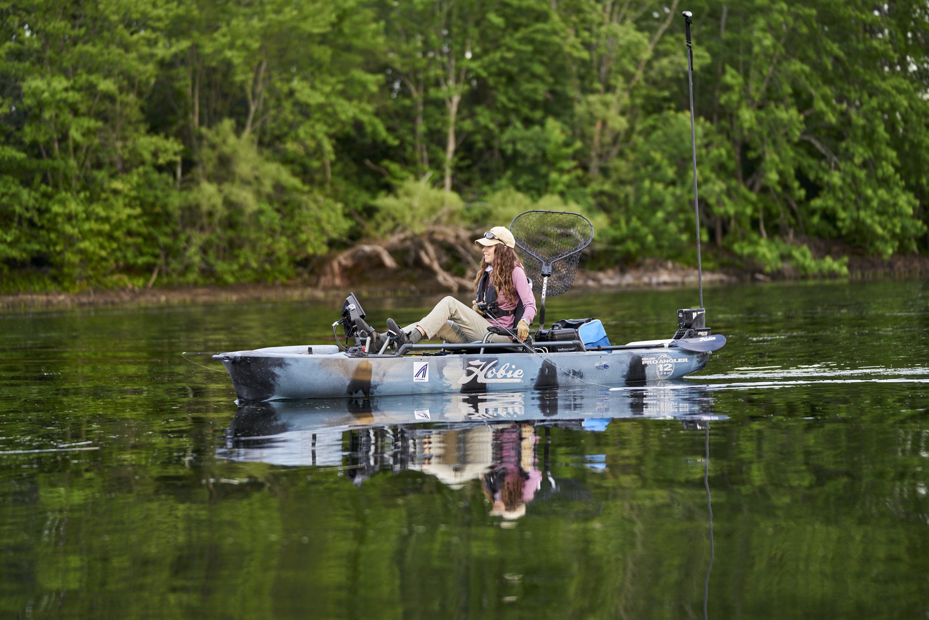 female angler fishing aboard a Hobie Pro Angler 12 fishing kayak